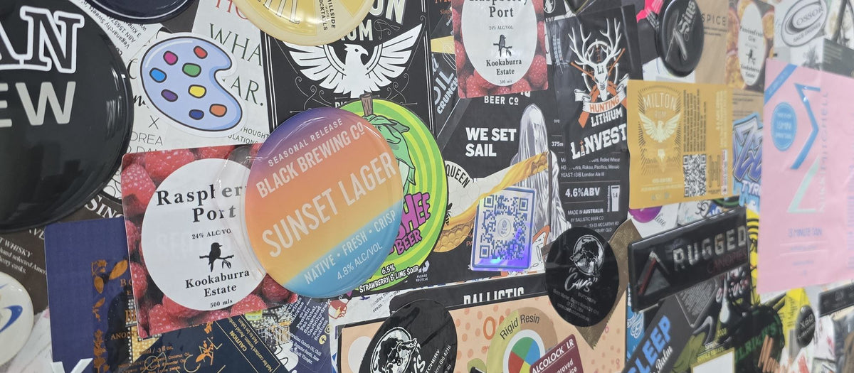Close-up of a wall covered in customer stickers and resin domed decals printed by Sticker Studio